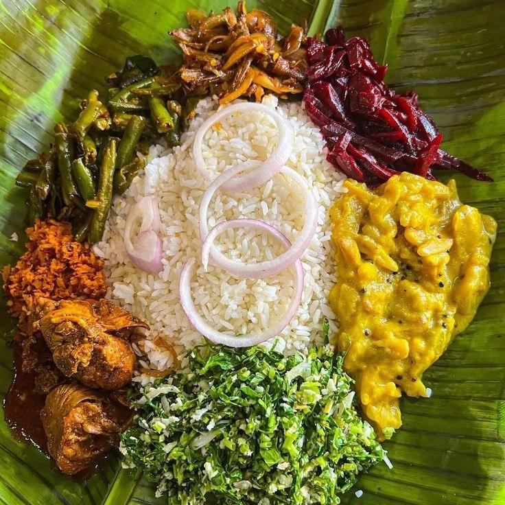 Traditional Sri Lankan rice and curry with vibrant spices and side dishes
