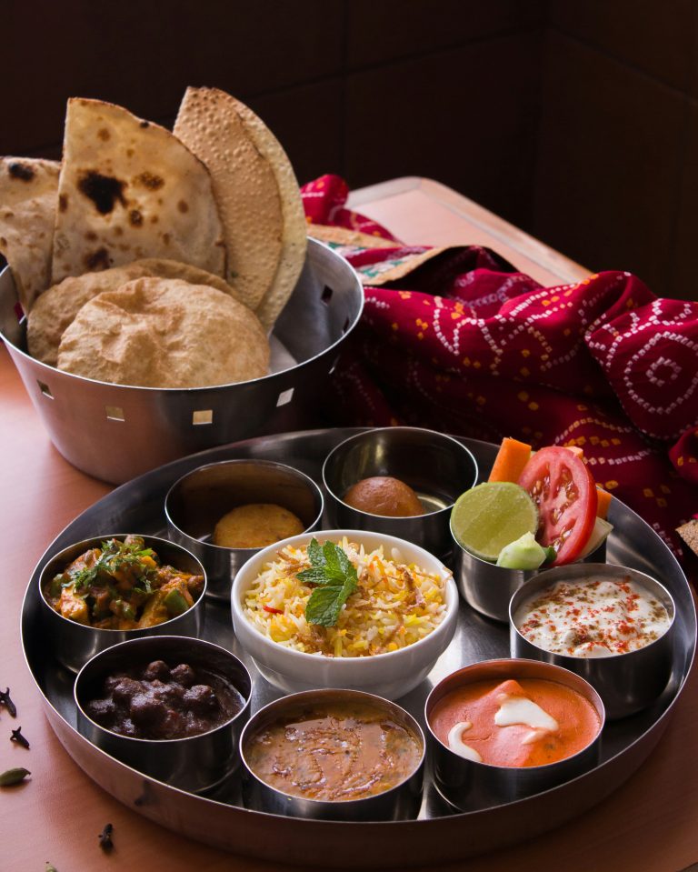 Traditional Nepali cuisine including momos and dal bhat served in a rustic setting representing local food culture