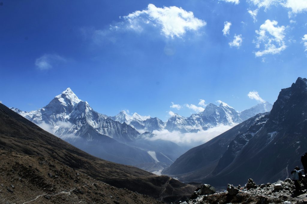 Snow-covered Himalayas in Nepal under a clear blue sky showcasing dramatic mountain peaks and natural beauty