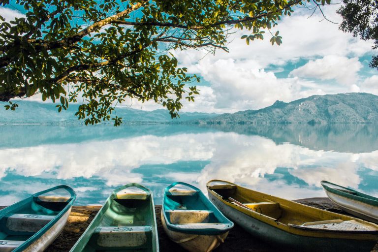 Peaceful Phewa Lake in Pokhara Nepal with reflections of the Annapurna mountains creating a serene landscape