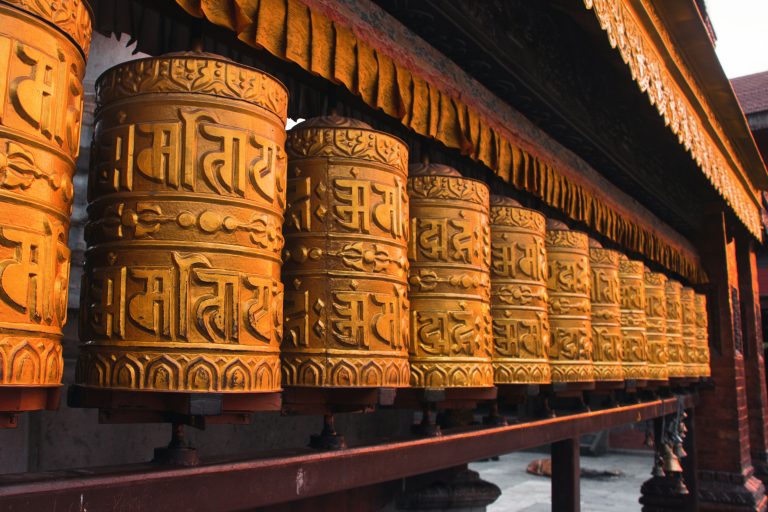 Buddhist monks and prayer wheels in a Nepal monastery representing spiritual life and religious traditions