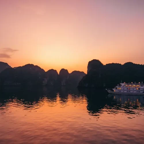 Cruise boat sailing through the limestone karsts of Ha Long Bay, Vietnam