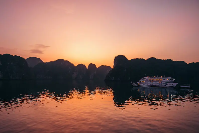Cruise boat sailing through the limestone karsts of Ha Long Bay, Vietnam