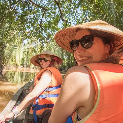 Travellers kayaking among the dramatic limestone islands of Ha Long Bay