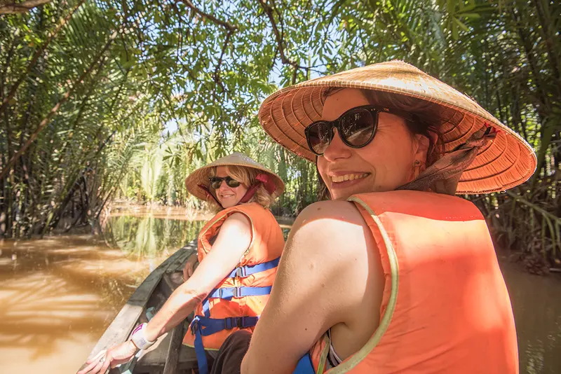 Travellers kayaking among the dramatic limestone islands of Ha Long Bay