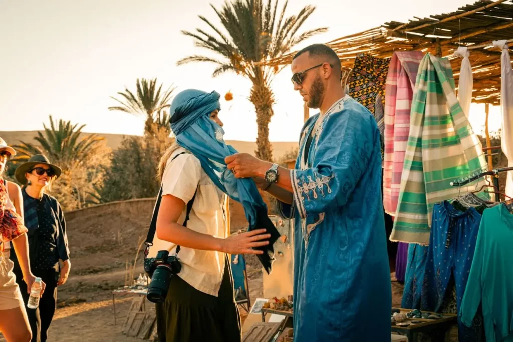 Travellers enjoying sunset in Ait Benhaddou, Morocco