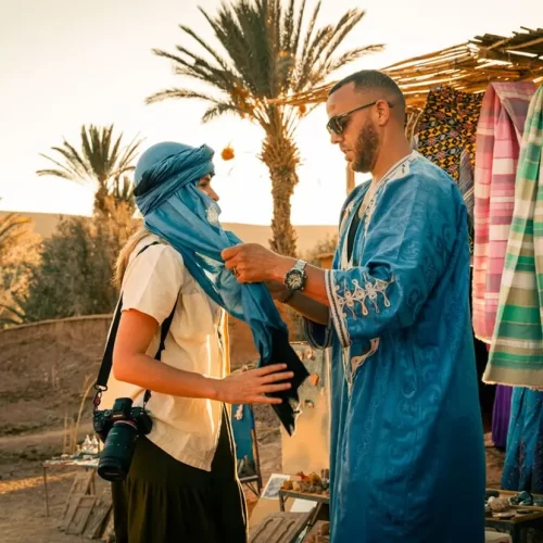 Travellers enjoying sunset in Ait Benhaddou, Morocco